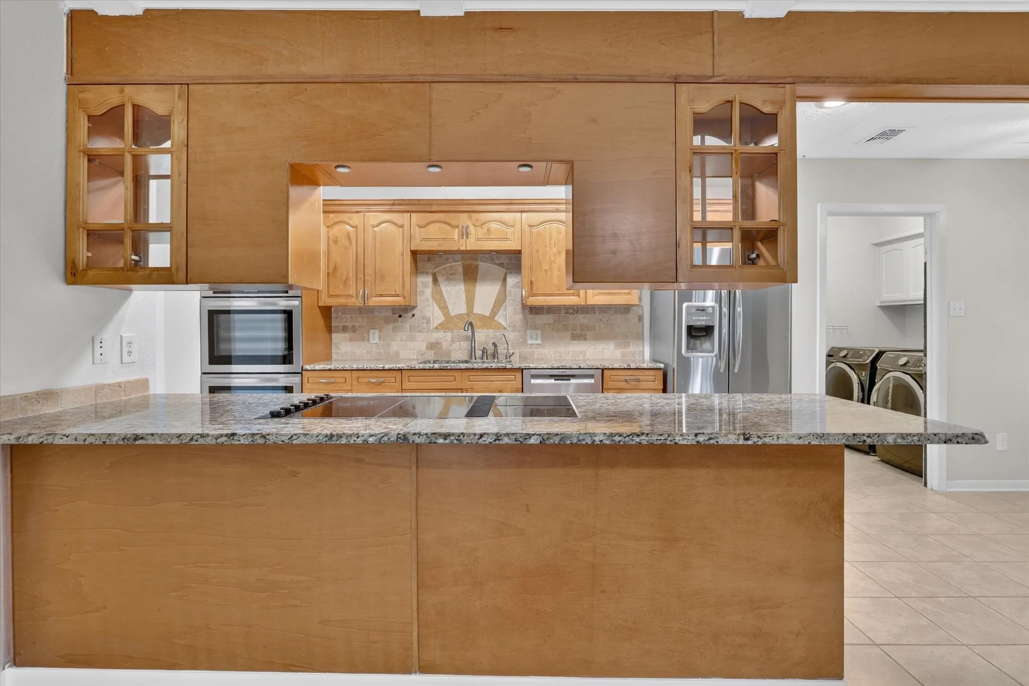 Kitchen featuring a built-in oven, cooktop, and dishwasher