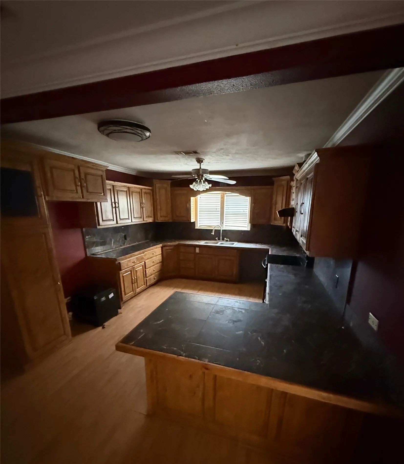 Kitchen featuring wood-finish flooring and extensive cabinetry