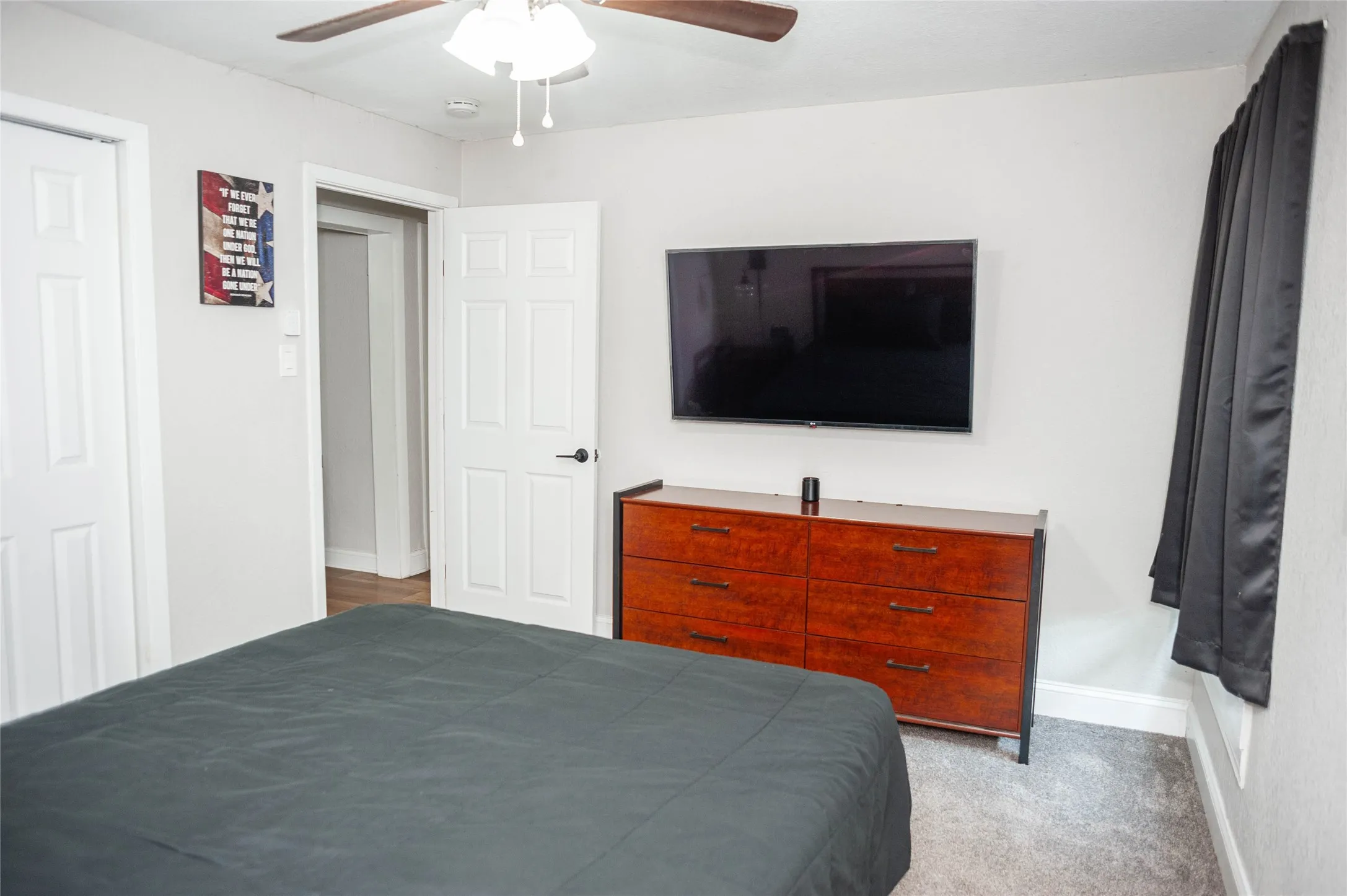 Light gray wall paint, recessed ceiling lighting, and a ceiling fan with light fixture