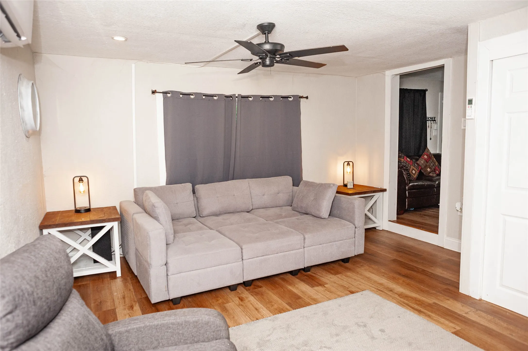 Hardwood-finish flooring, recessed lighting, and a ceiling fan with integrated lighting