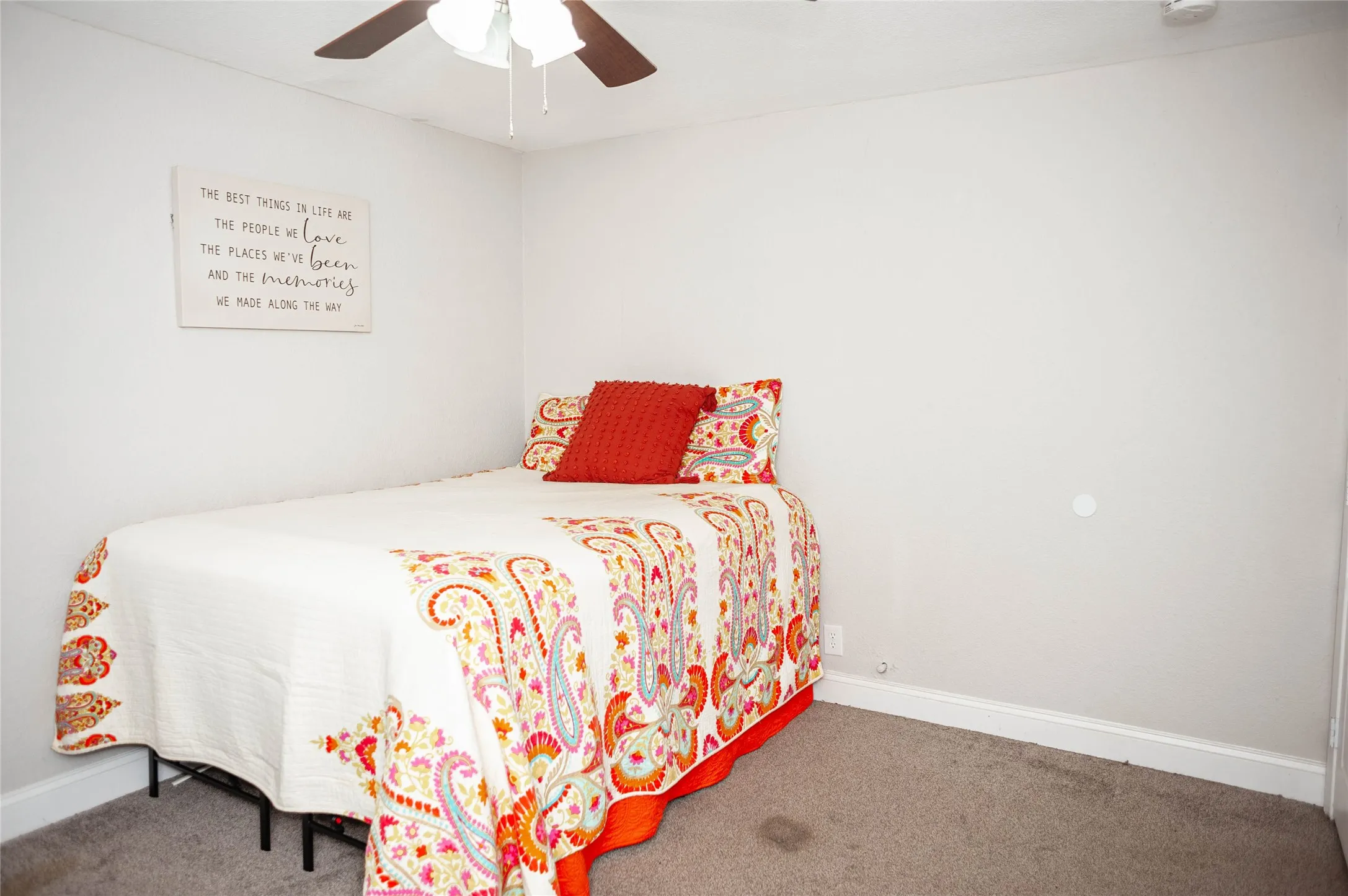 Carpeted flooring with a ceiling fan overhead