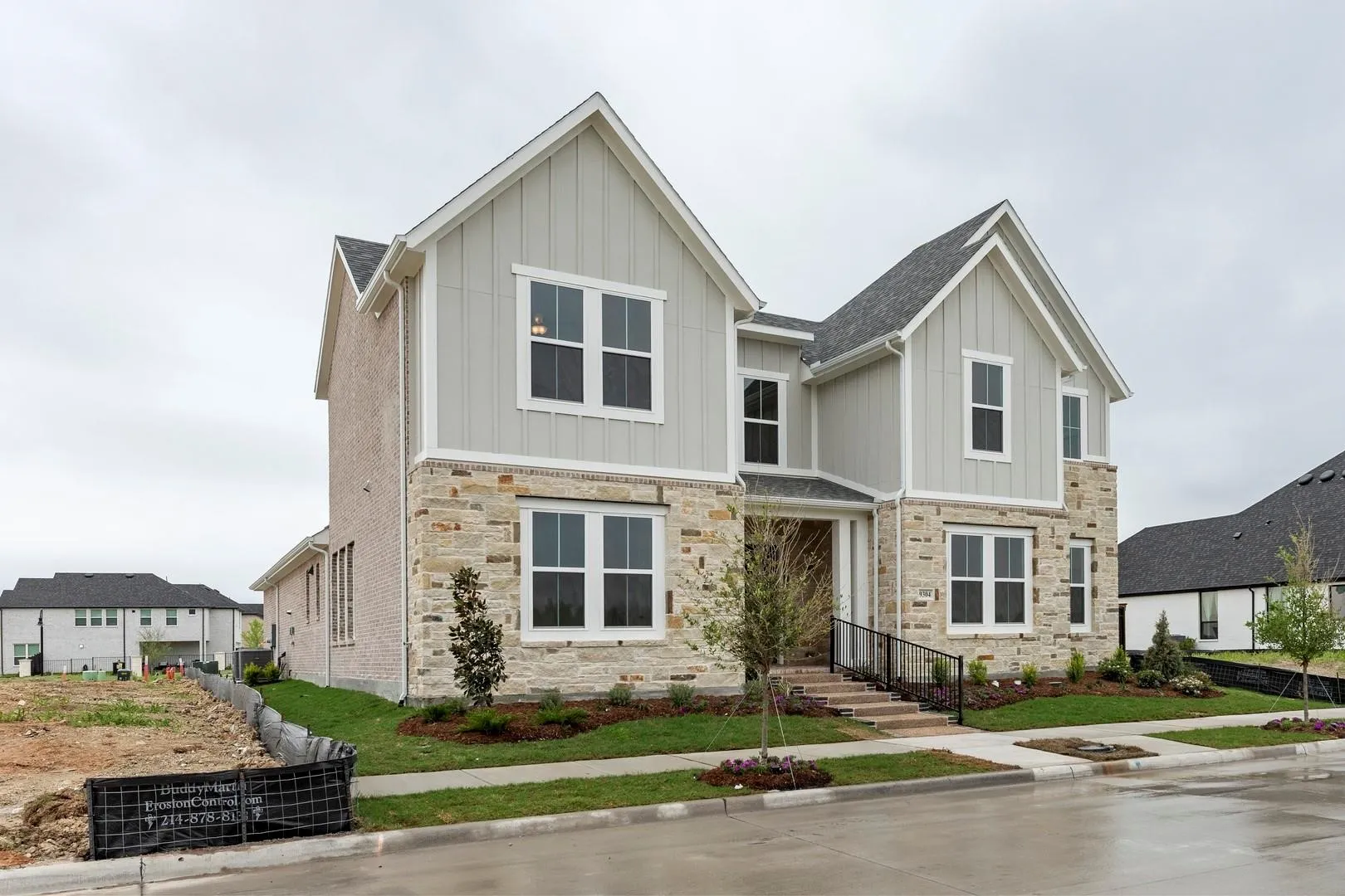 Contemporary two-story residence featuring a stone and board-and-batten facade