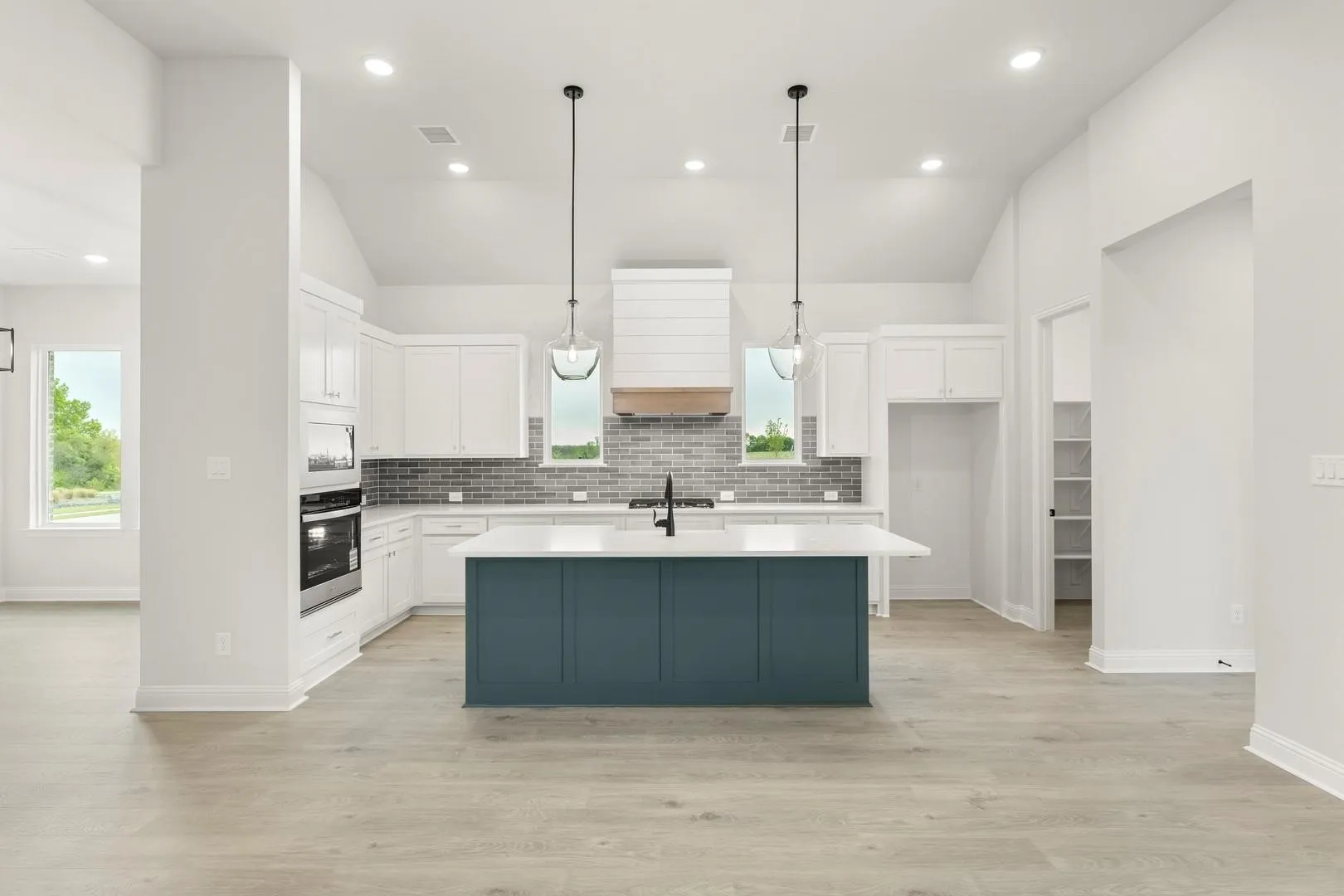 Modern kitchen featuring a blue-toned island with a white countertop