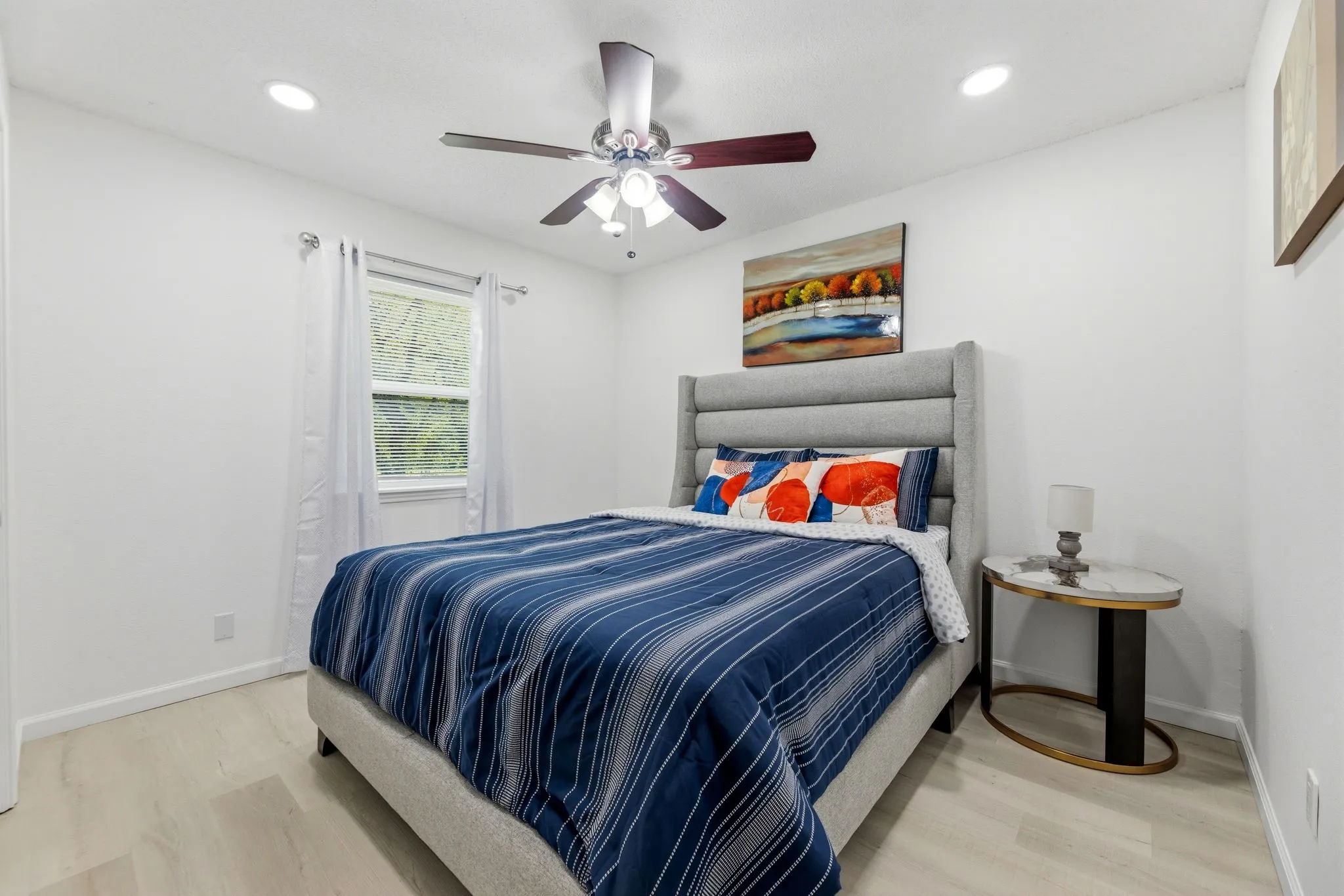 Bedroom featuring light wood-finish flooring and white walls