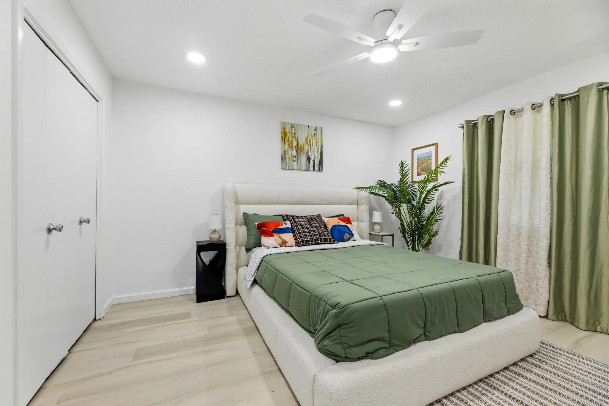 Bedroom featuring light wood-finish flooring, recessed lighting, and a ceiling fan