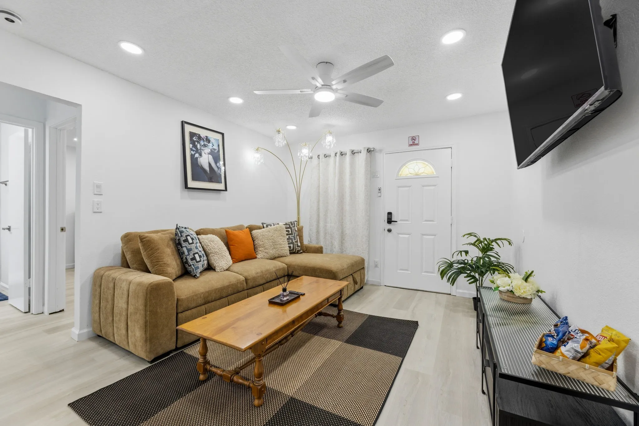 Living area with light-toned wood-finish flooring