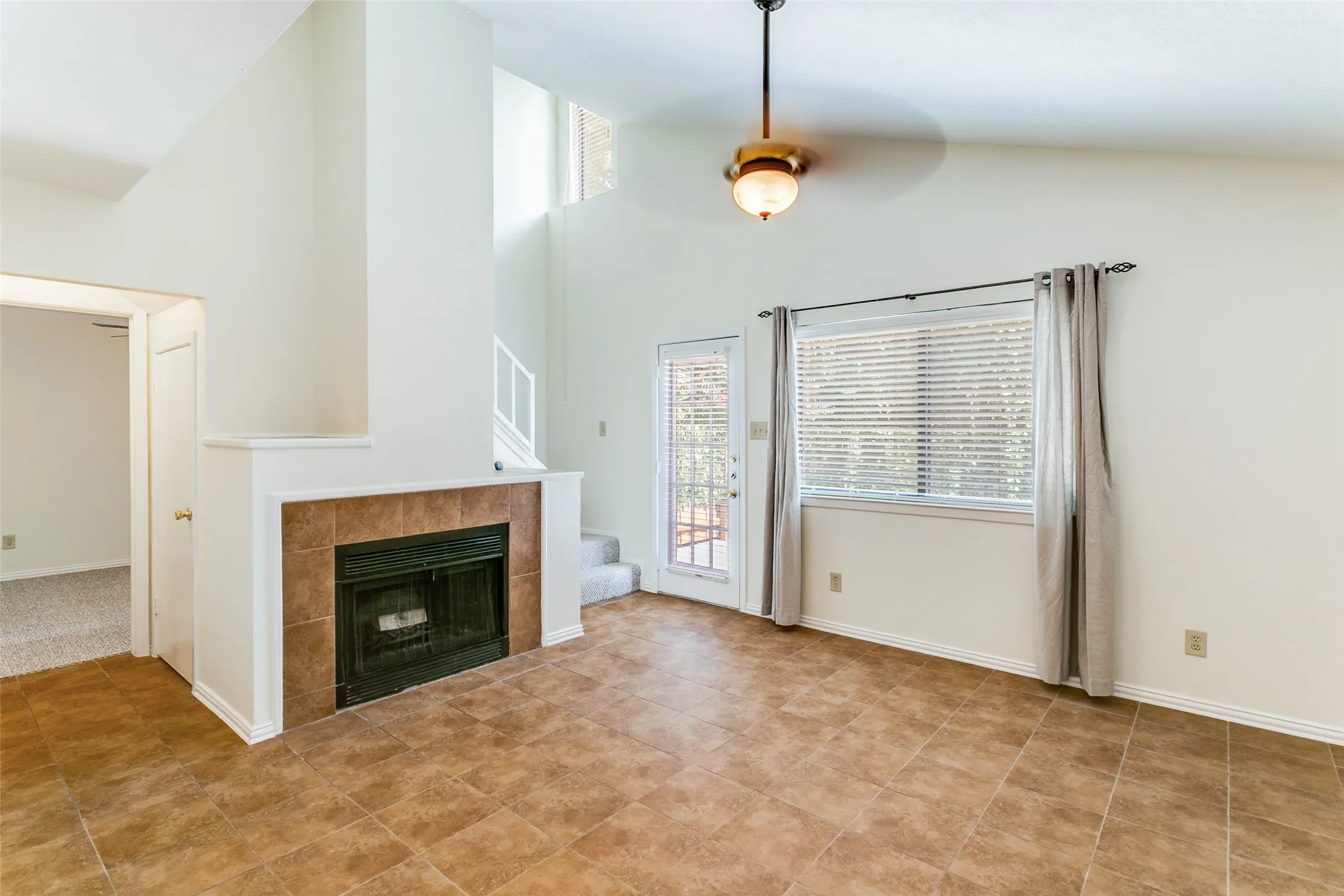 The living room has a fireplace and acess to the private patio.