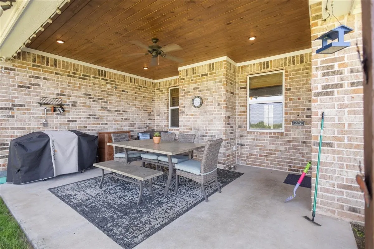Extended covered patio with wood ceiling, ceiling fan