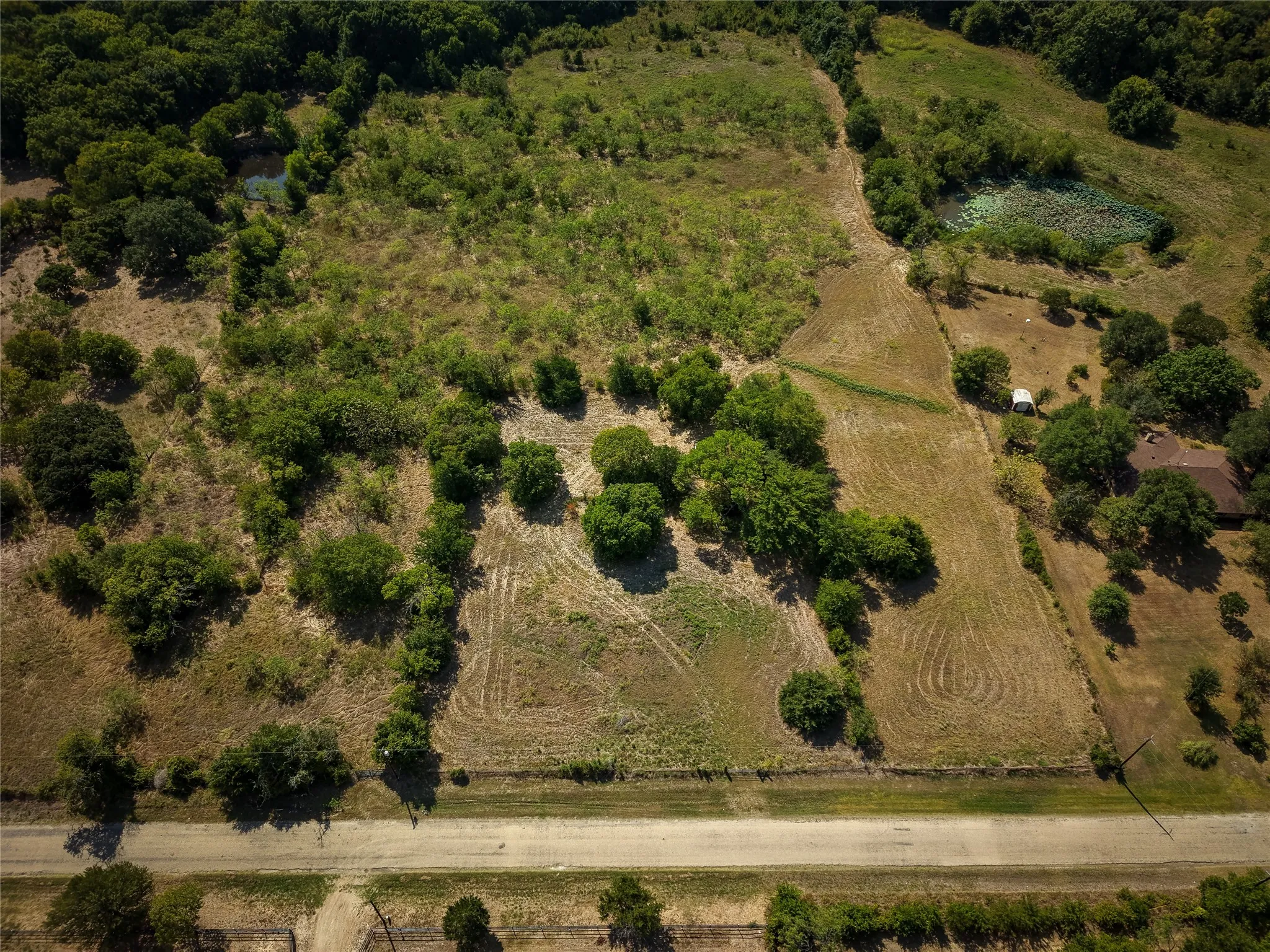 Expansive undeveloped land featuring a combination of wooded areas and open clearings