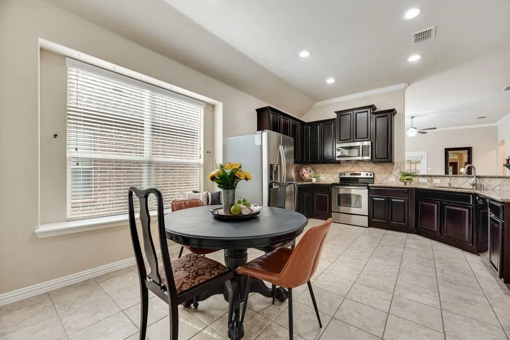 Dining area with ornamental molding, light tile patterned floors, recessed lighting, and ceiling fan