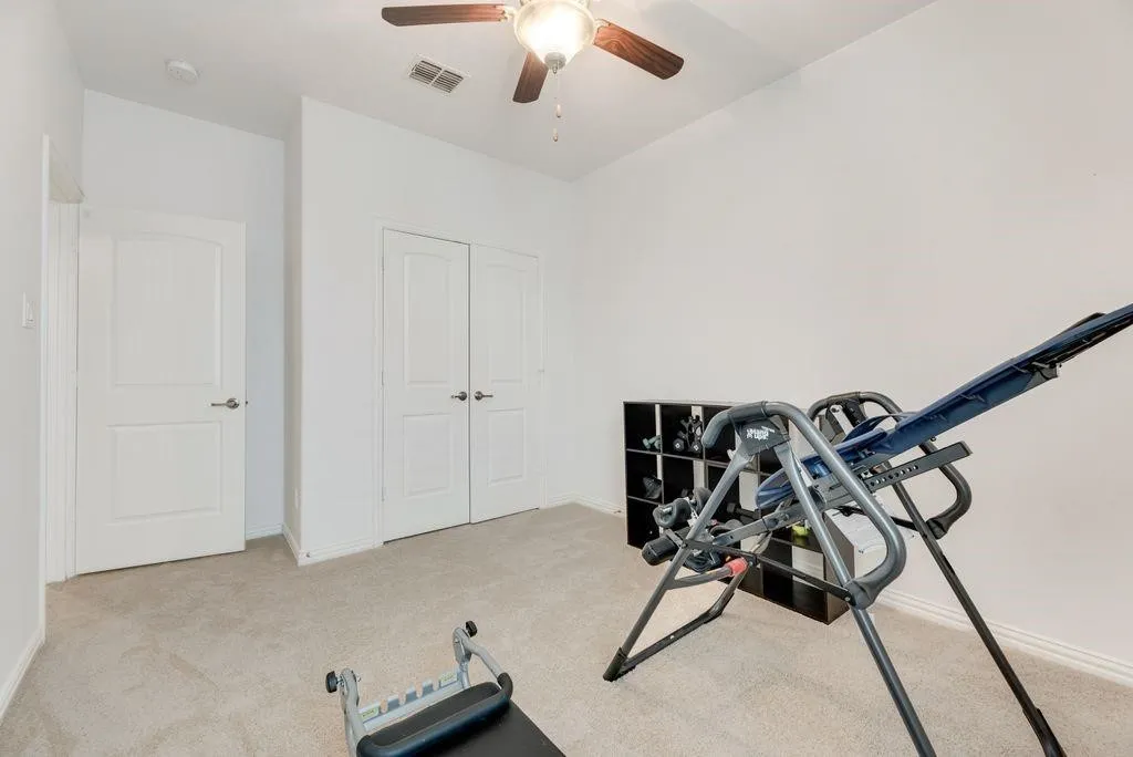 Workout room featuring carpet and ceiling fan