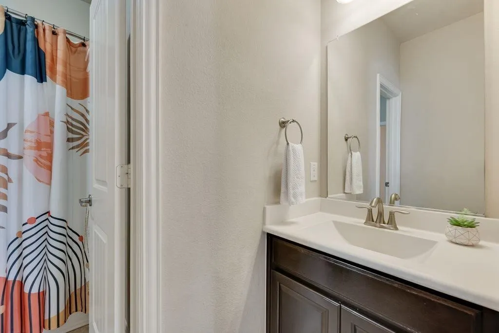 Full bathroom featuring vanity and a shower with curtain