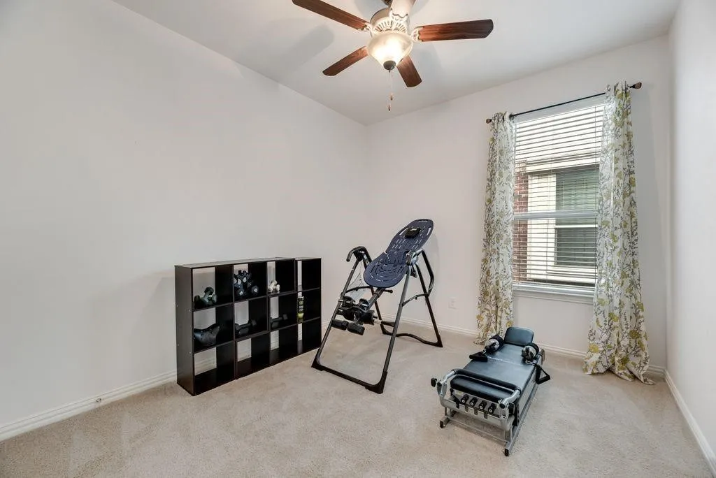 Workout area with carpet floors and ceiling fan