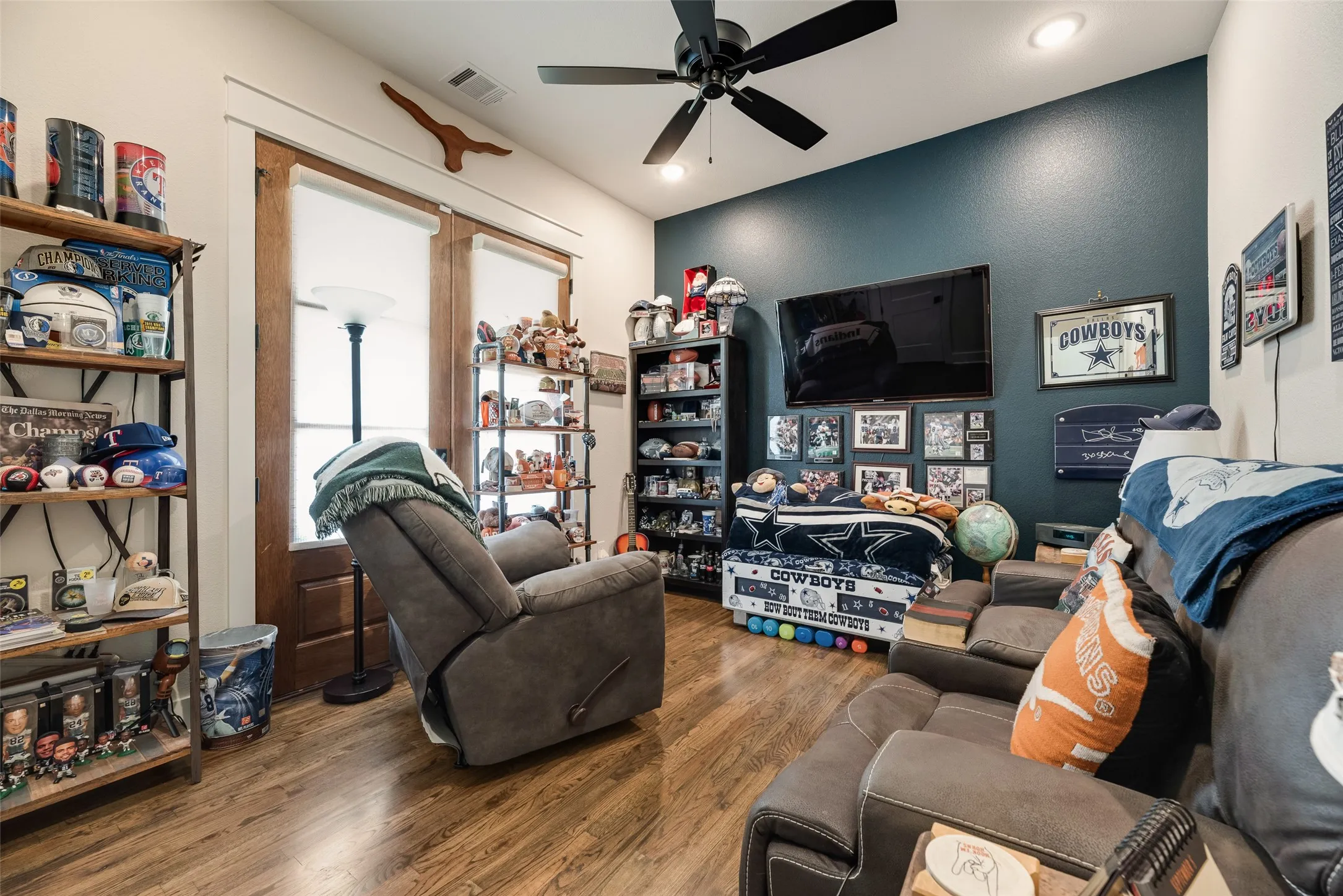 Room featuring wood-finish flooring, a contemporary ceiling fan with integrated lighting, and recessed ceiling lights