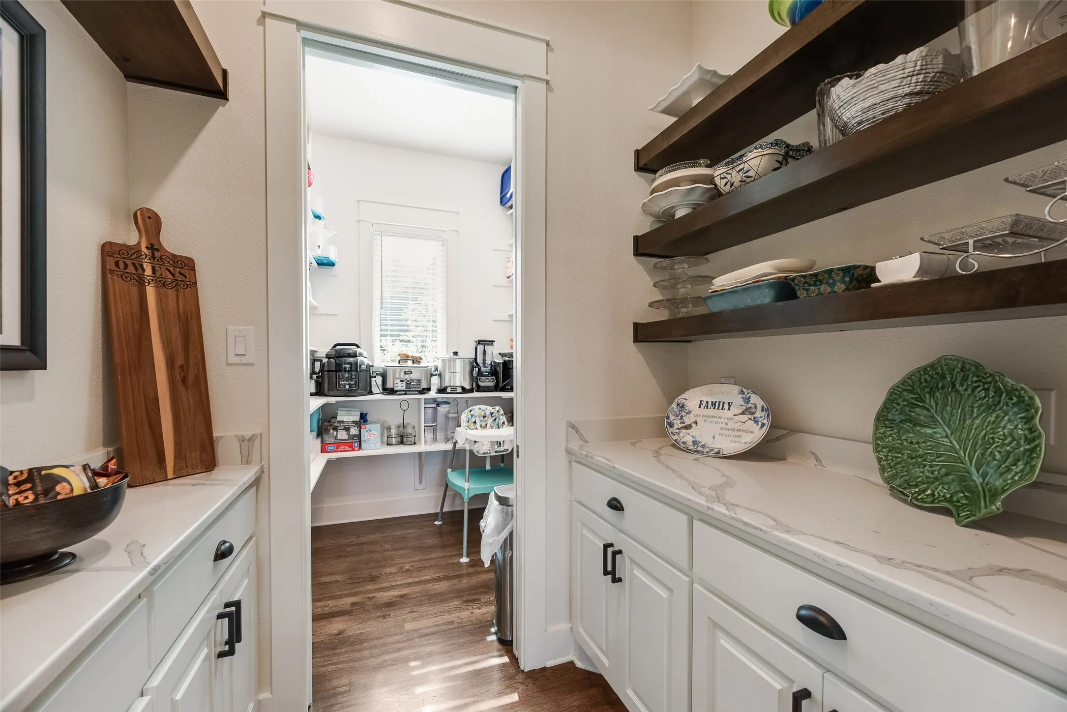 Butler's Pantry leads to a large walk-in pantry.