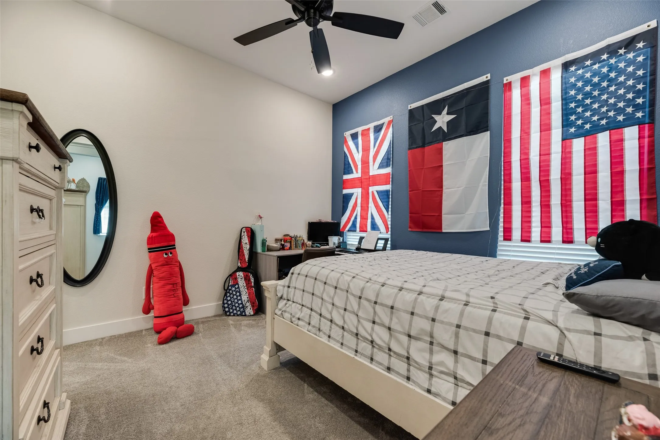 Bedroom featuring a ceiling fan with light fixture, two-tone painted walls, and carpet flooring
