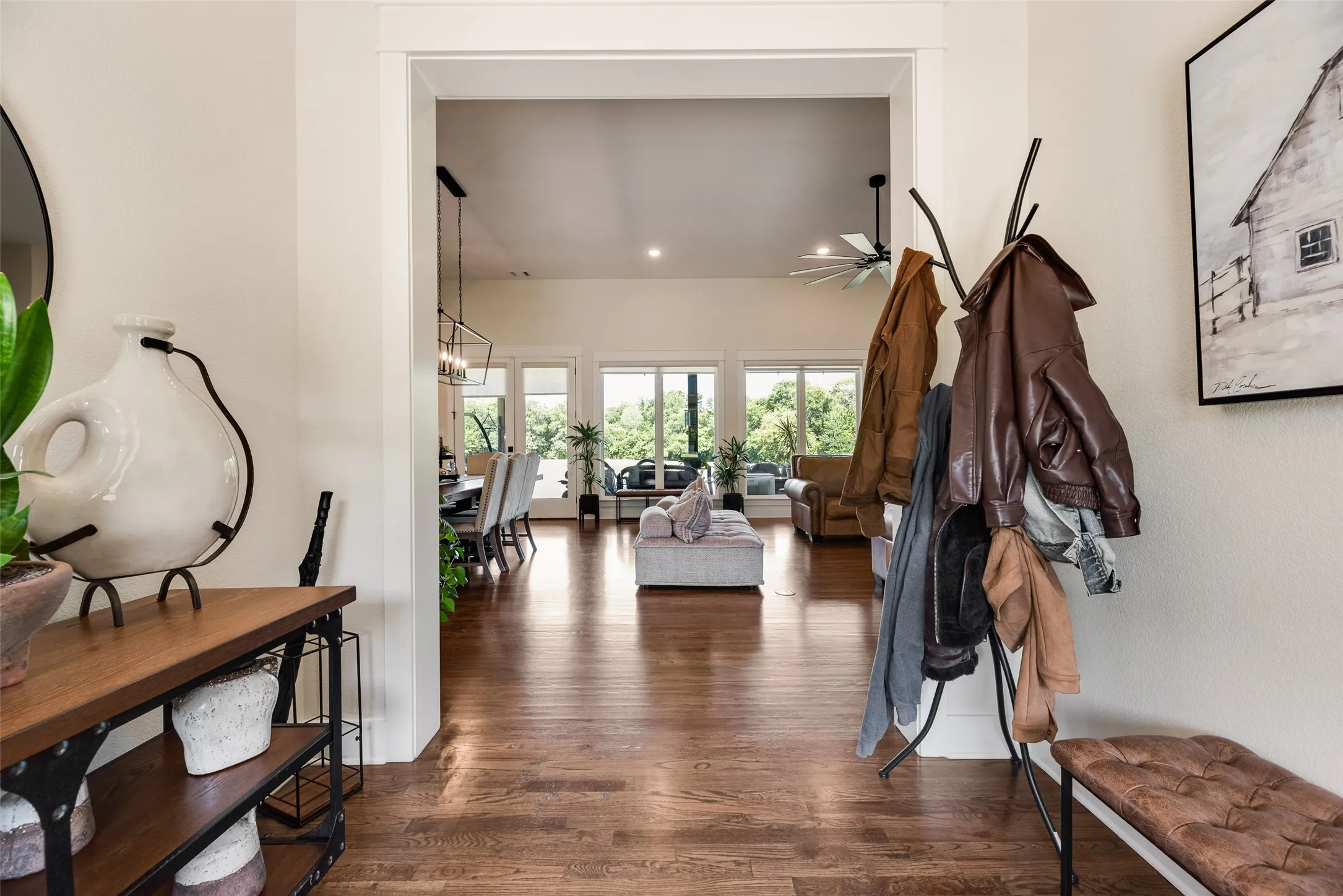 Expansive property featuring a modern residence with a dark roof and a long paved driveway