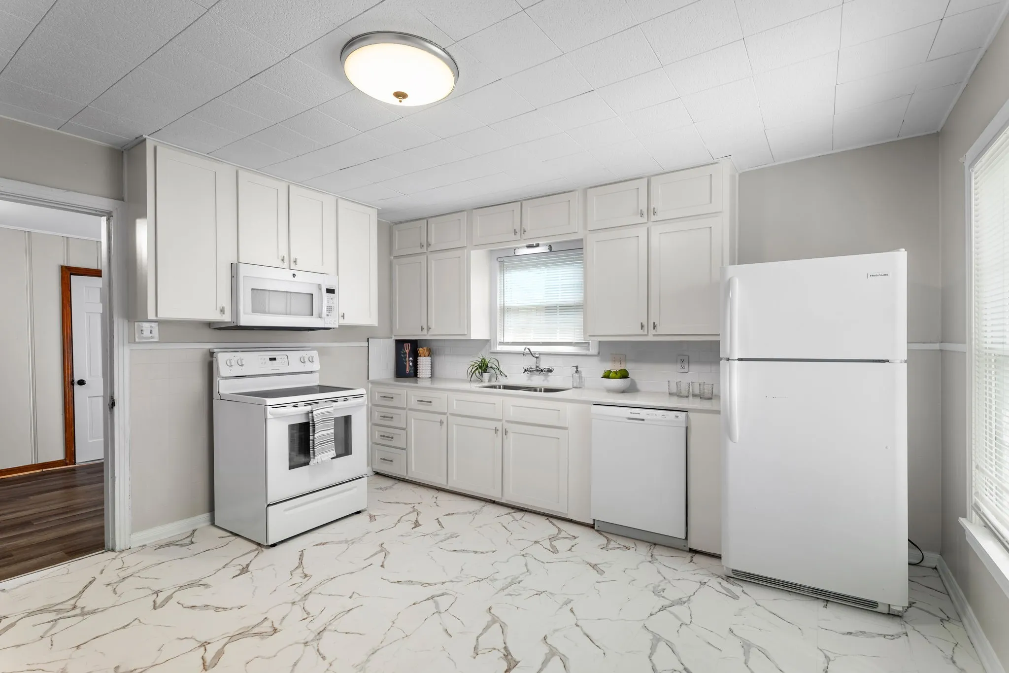 Kitchen with new quartz countertops & vinyl tile flooring