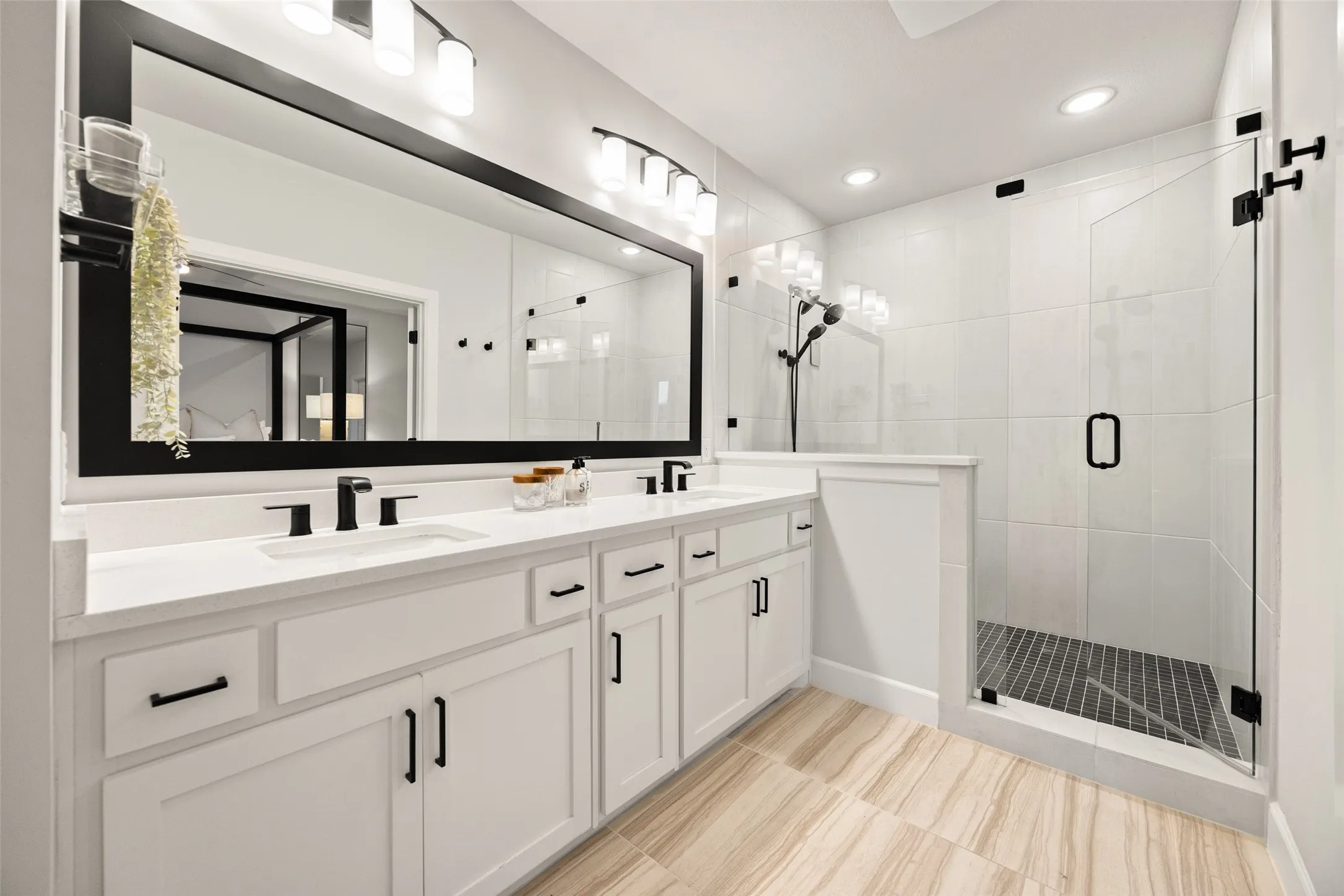 A separate glass-enclosed shower and high-end finishes make the morning routine feel like a luxury