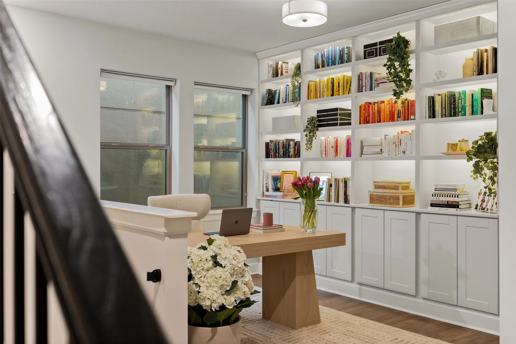 This dedicated workspace is a dream for productivity, featuring custom built-in cabinetry that offers a place for everything