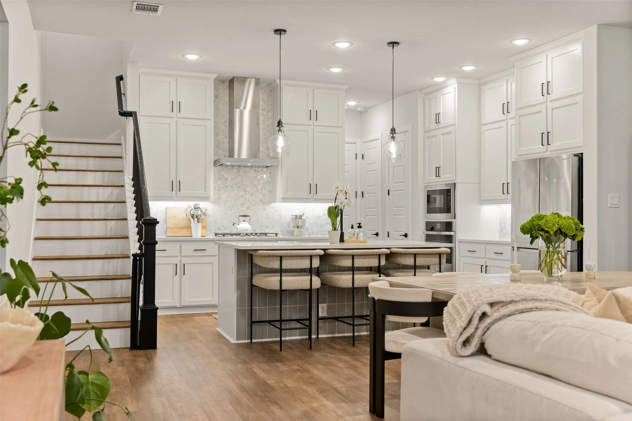 The open layout of the first floor makes it easy to host a crowd, allowing guests to move freely between the kitchen and living area without ever feeling separated from the action