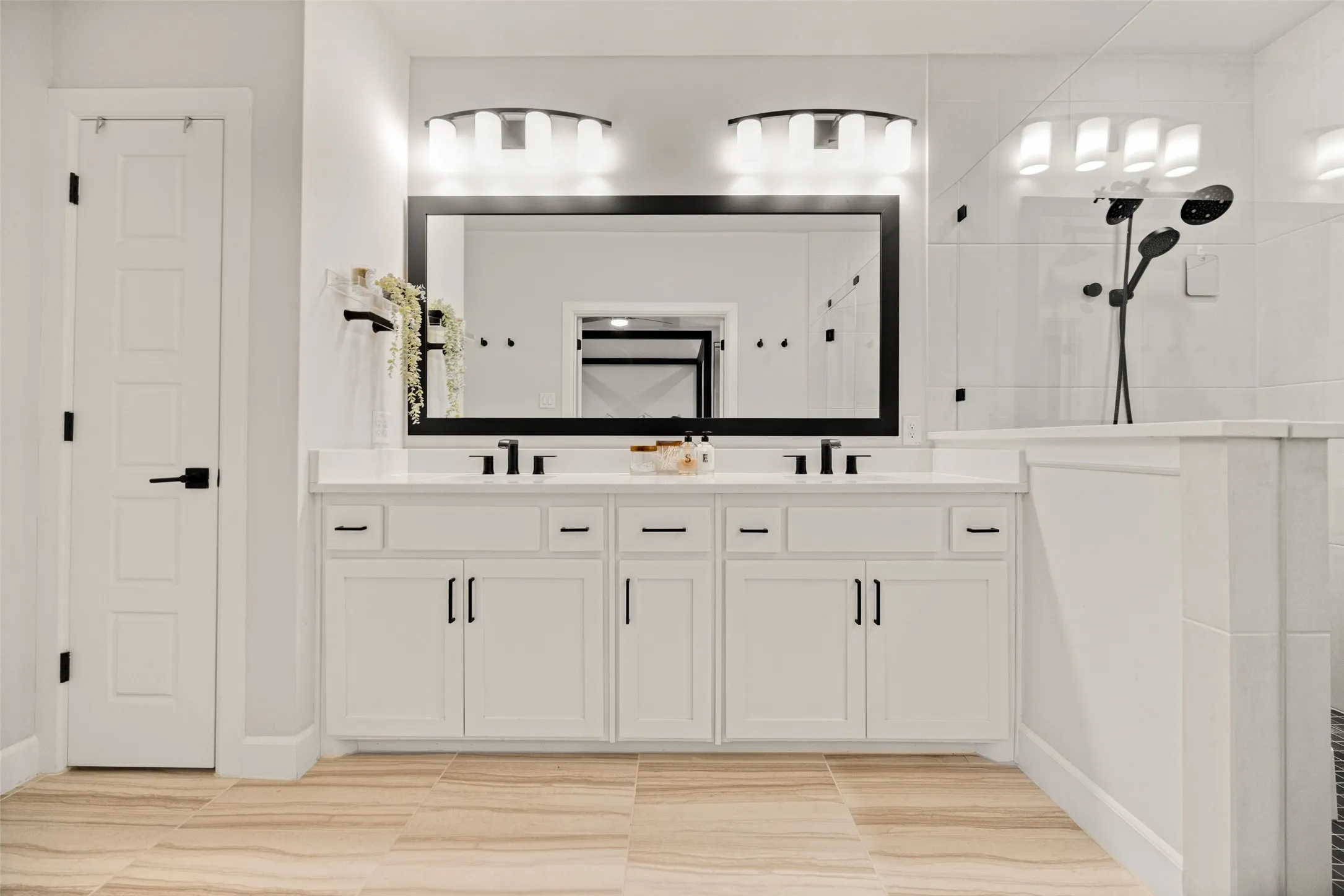 This spa-inspired space features a dual vanity and a large soaking tub, creating a private spot for relaxation
