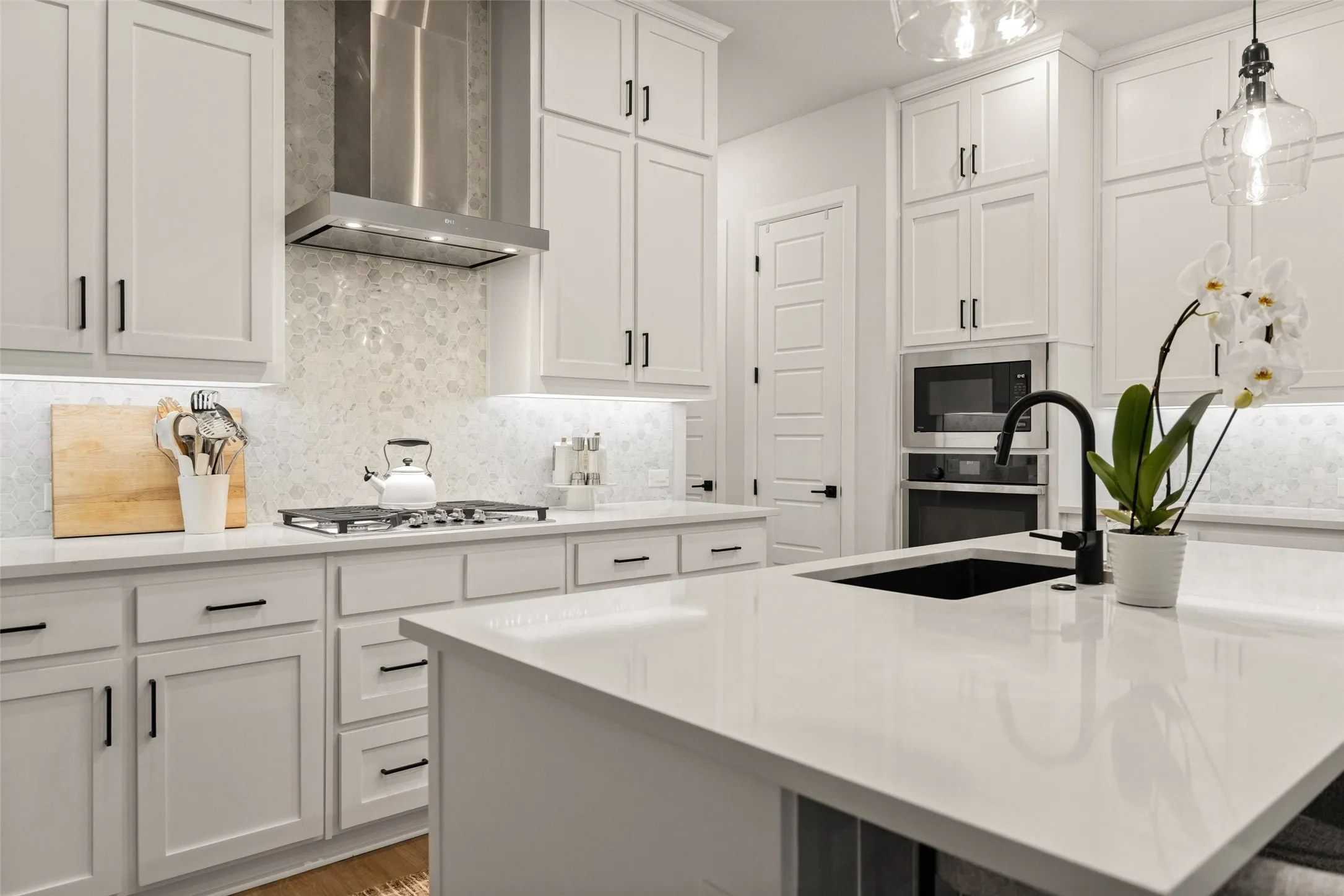 High-end stainless steel appliances and a tile backsplash bring a refined, high-quality feel to your daily meal prep