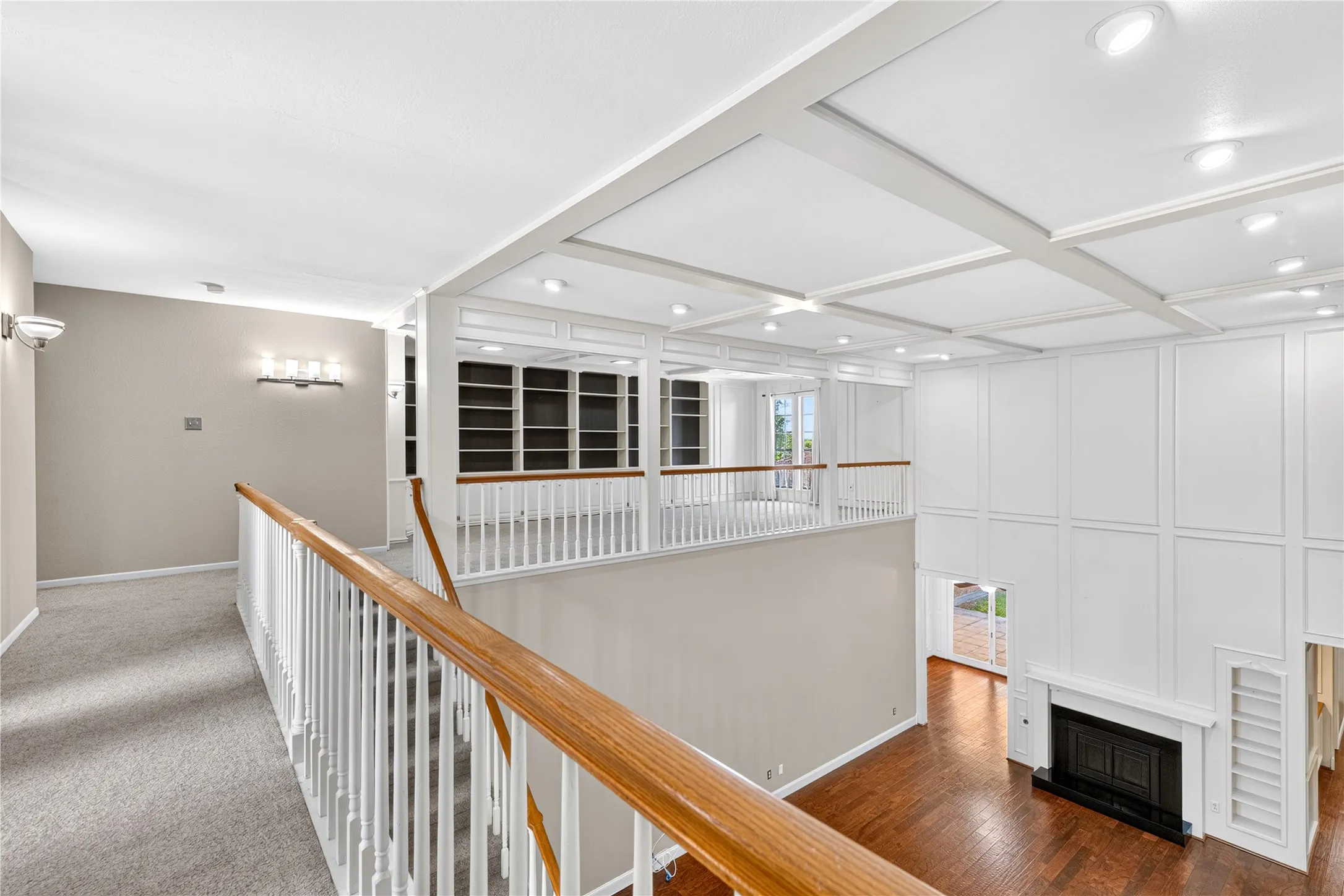 Nice overview of the downstairs fireplace and built in shelving.  To the top of the stairs and left is the perfect study.