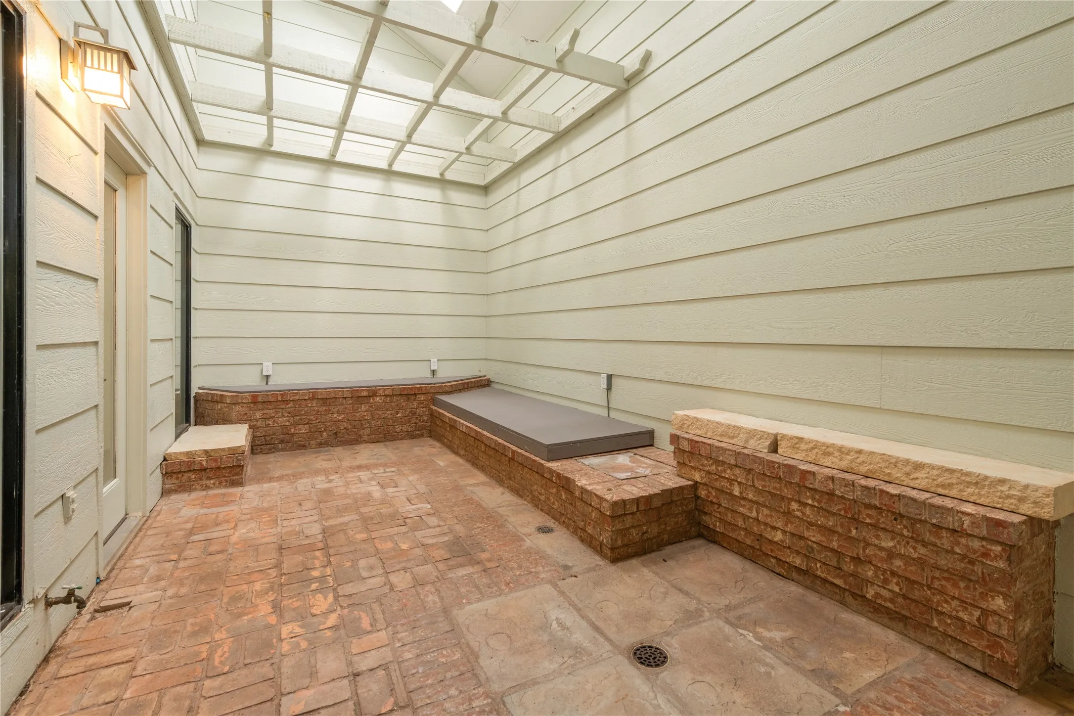 Atrium has skylights overhead, is heated and cooled.  Built in brick planters and floor drains.