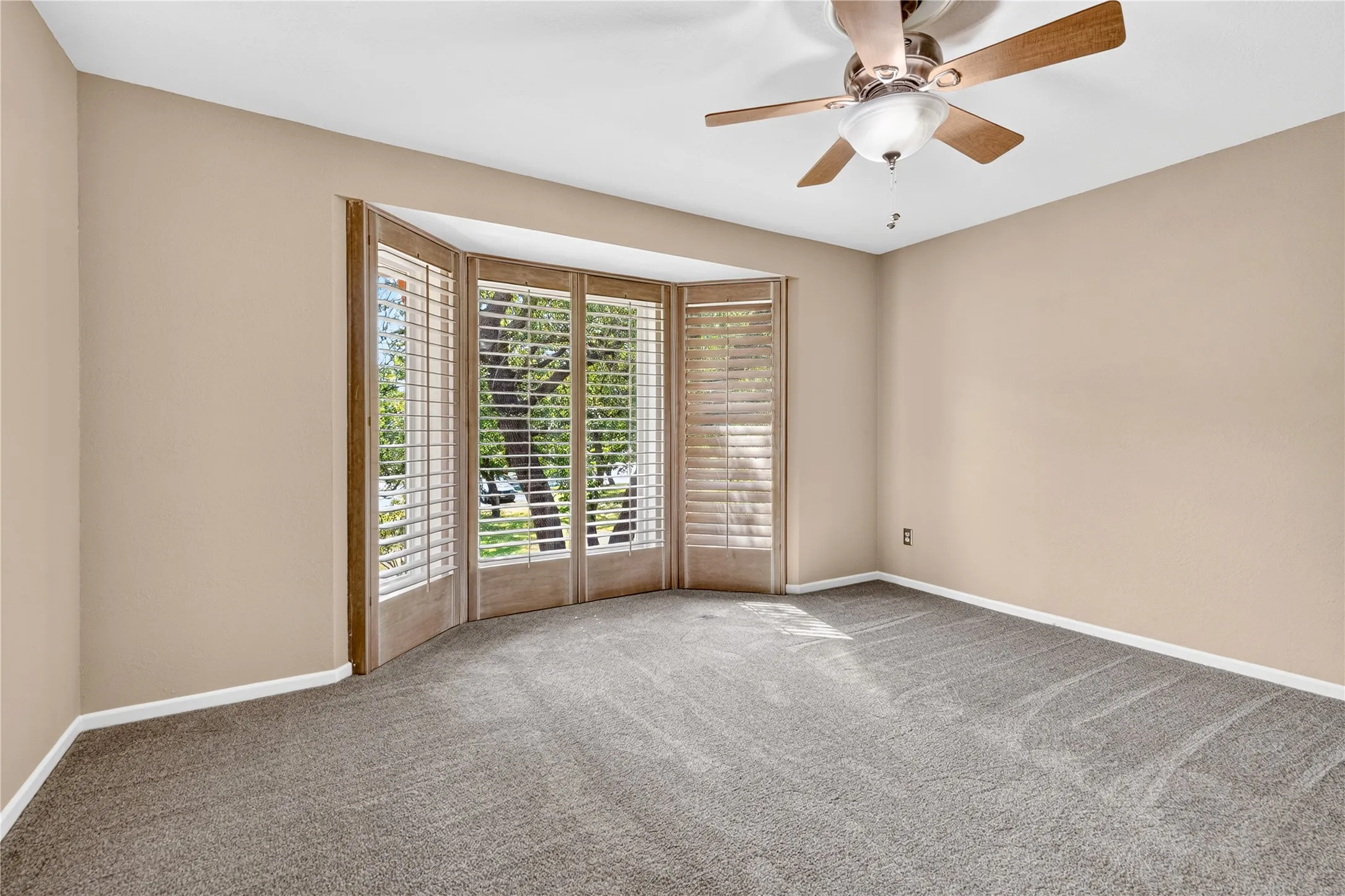 Second upstairs bedroom.  Wood louvered shutters.