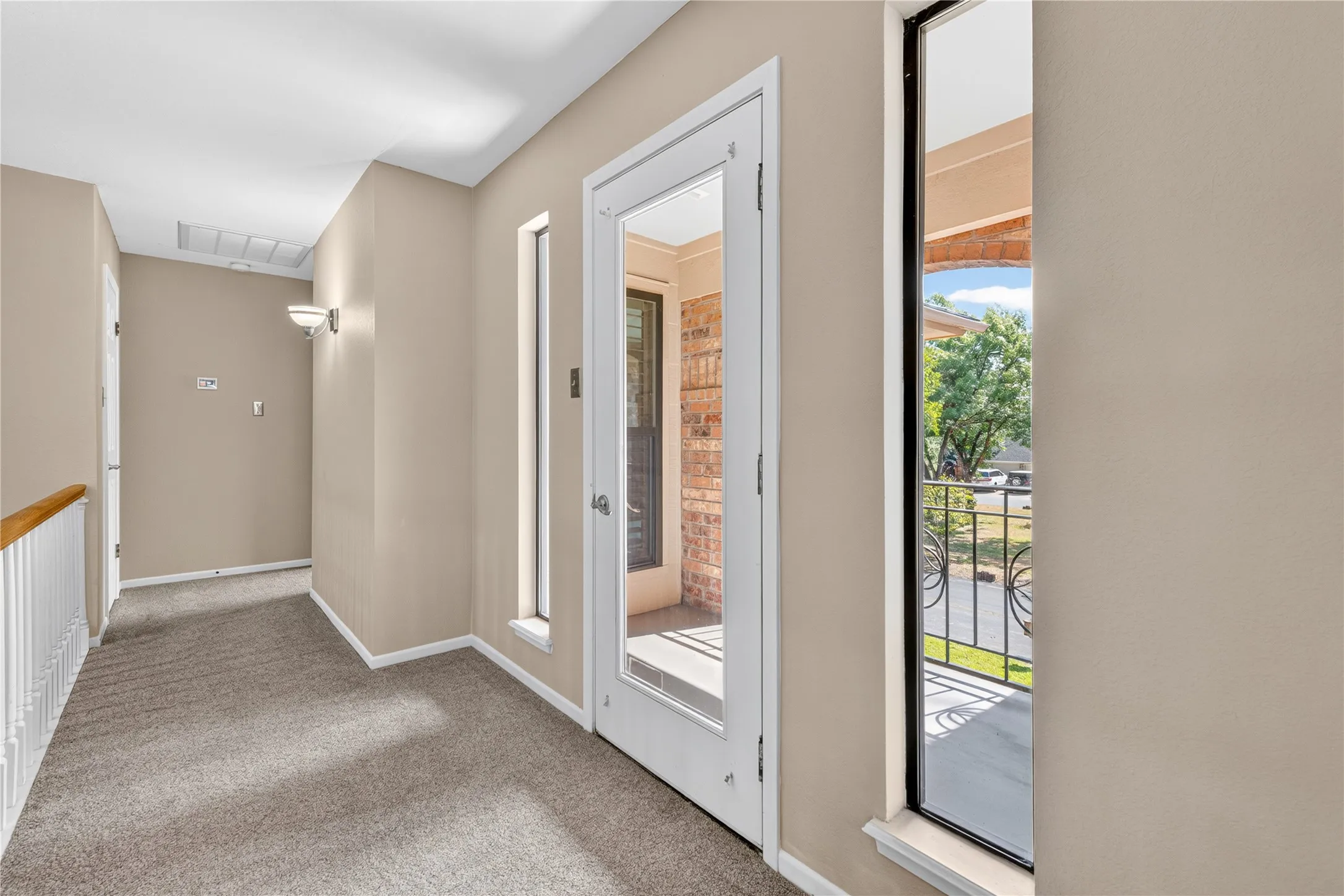 Open to living below hallway connects two upstairs bedrooms and entrance to balcony.