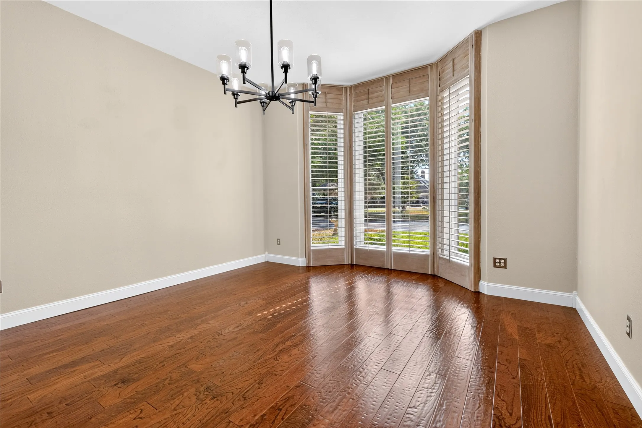 Located adjacent to the kitchen and foyer of the home is a formal dining room with wood louver shutters from floor to ceiling.