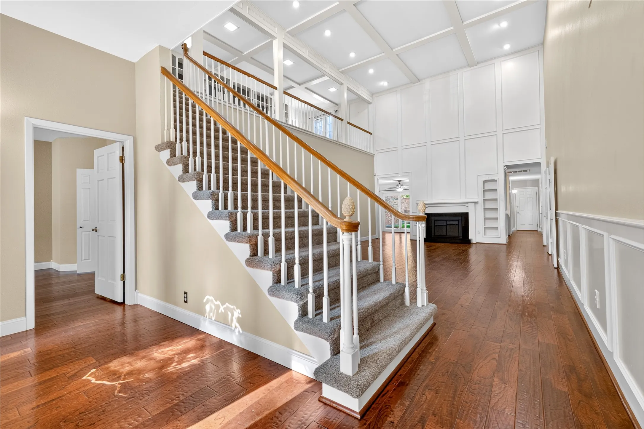 Step inside to gorgeous hand scraped engineered wood floors and an impressive staircase to the second floor library.