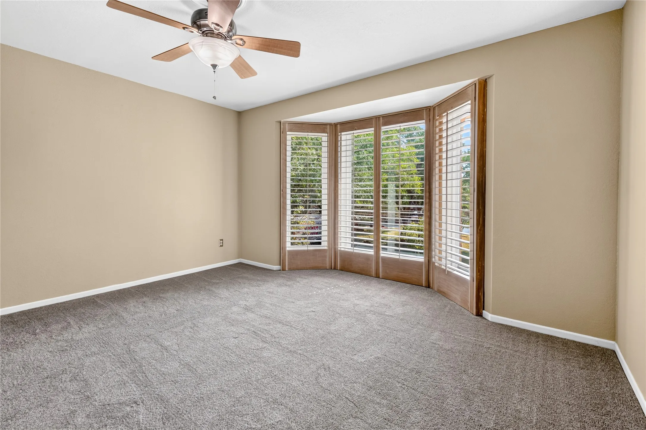 Third bedroom with wood louvered shutters