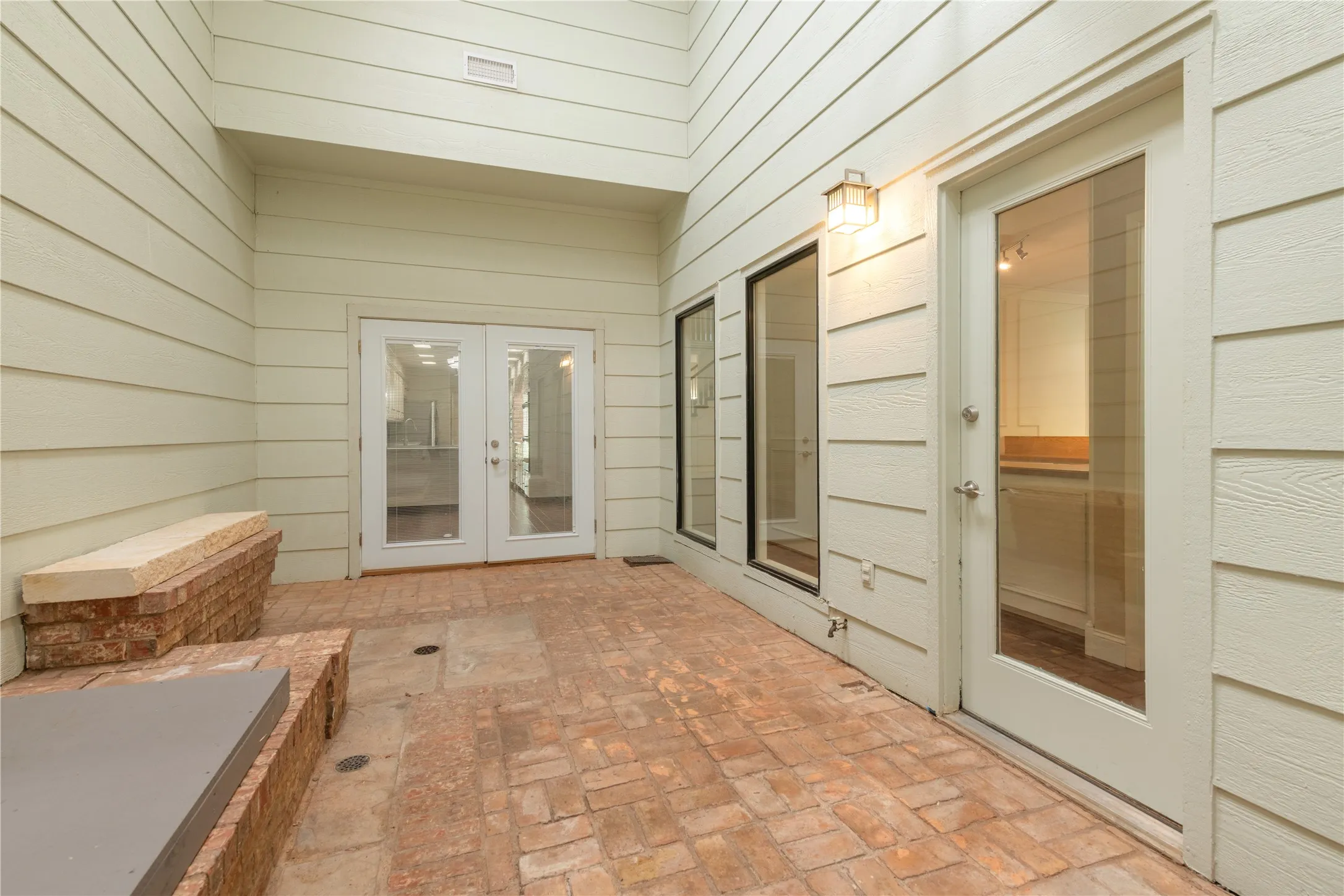 View of closed double doors into breakfast area and side windows and doorway to wet bar and half bath.