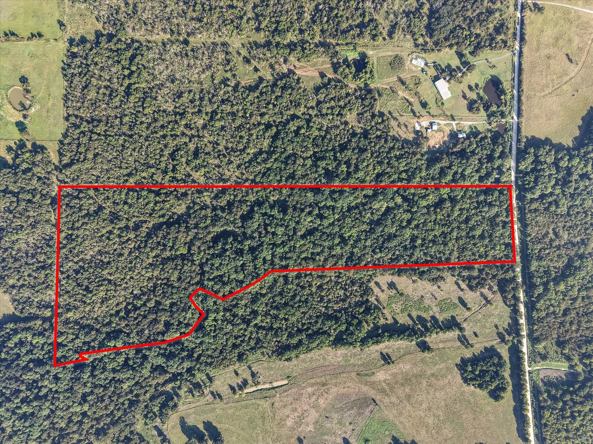 Aerial view with approximate boundary lines in red. SW CR 2340 is along the right.