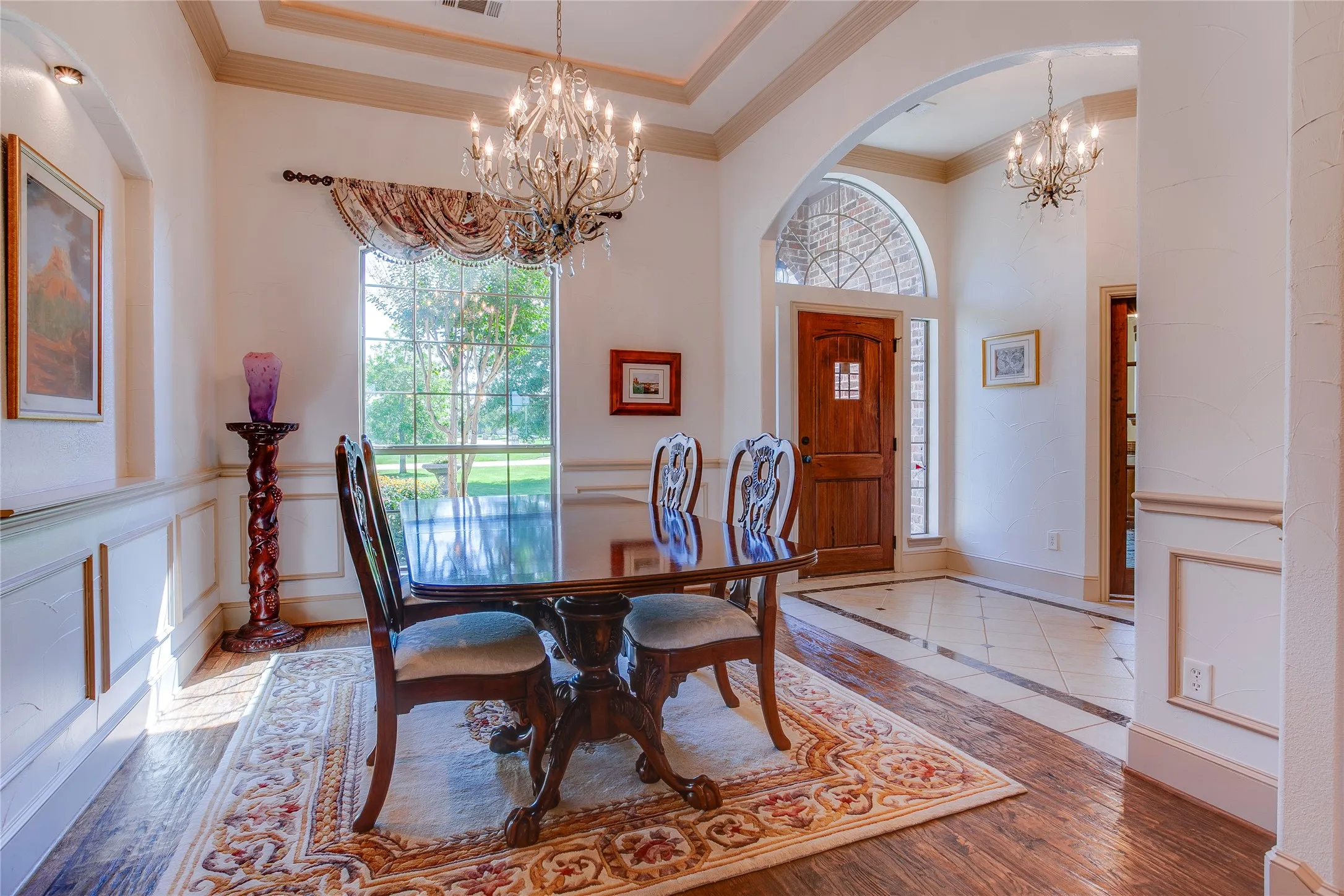 Formal dining features tray ceiling with accent lighting