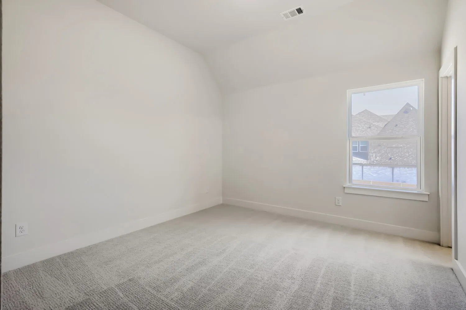 Soft gray carpeting with white baseboards and neutral wall paint