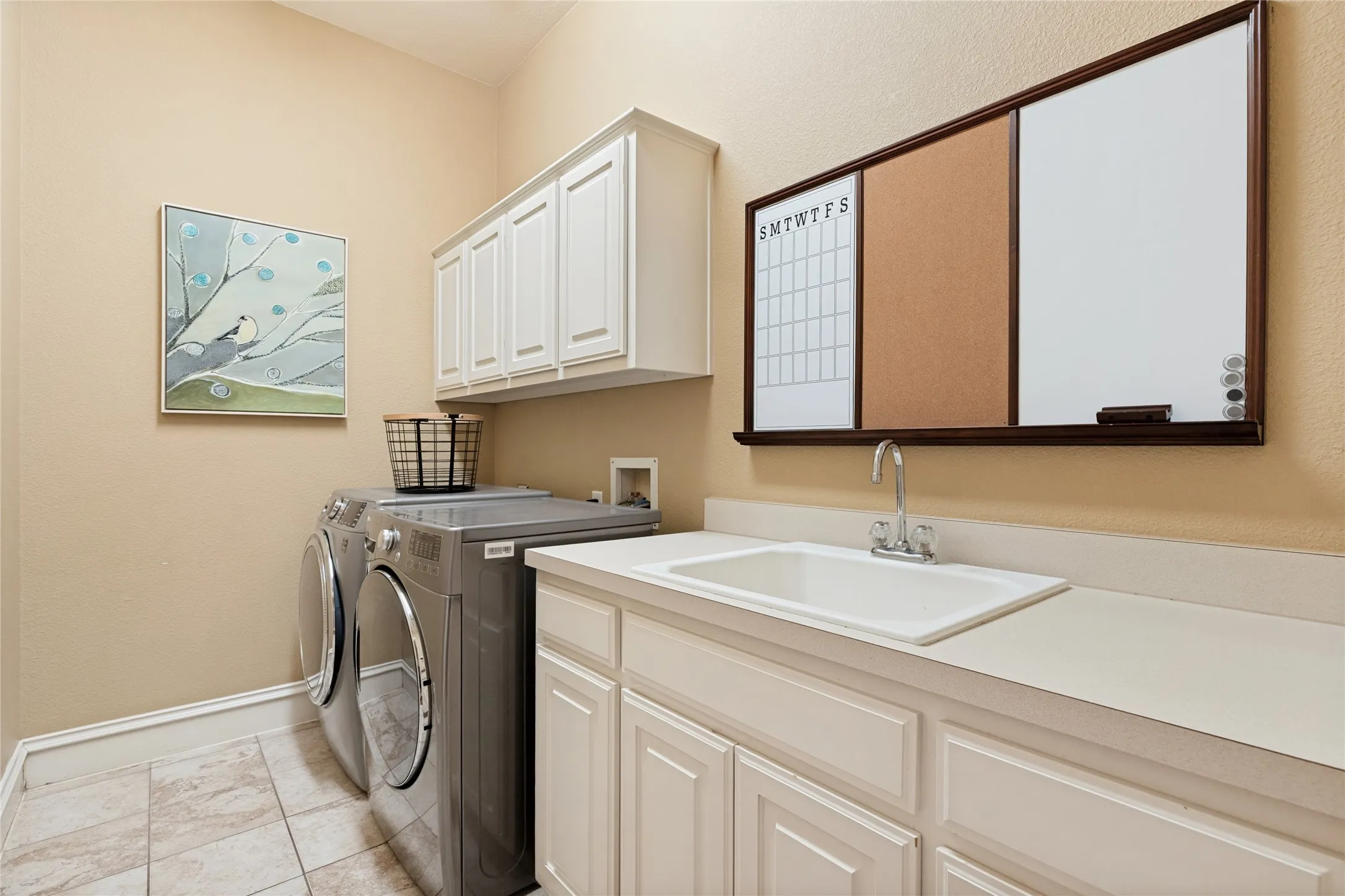 Large Utility Room with Full size washer-dryer area, sink, folding area and cabinets AND Utility Sink