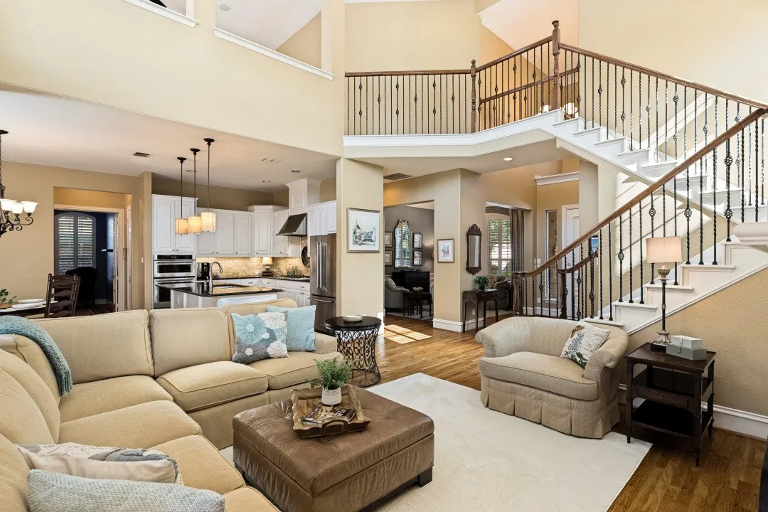 Living area with view of staircase and kitchen