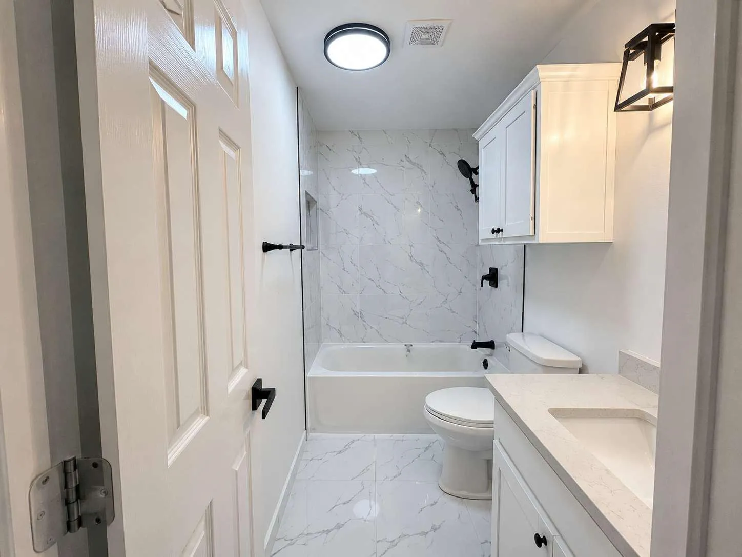 Bathroom featuring a white vanity with an integrated sink and light-colored countertop