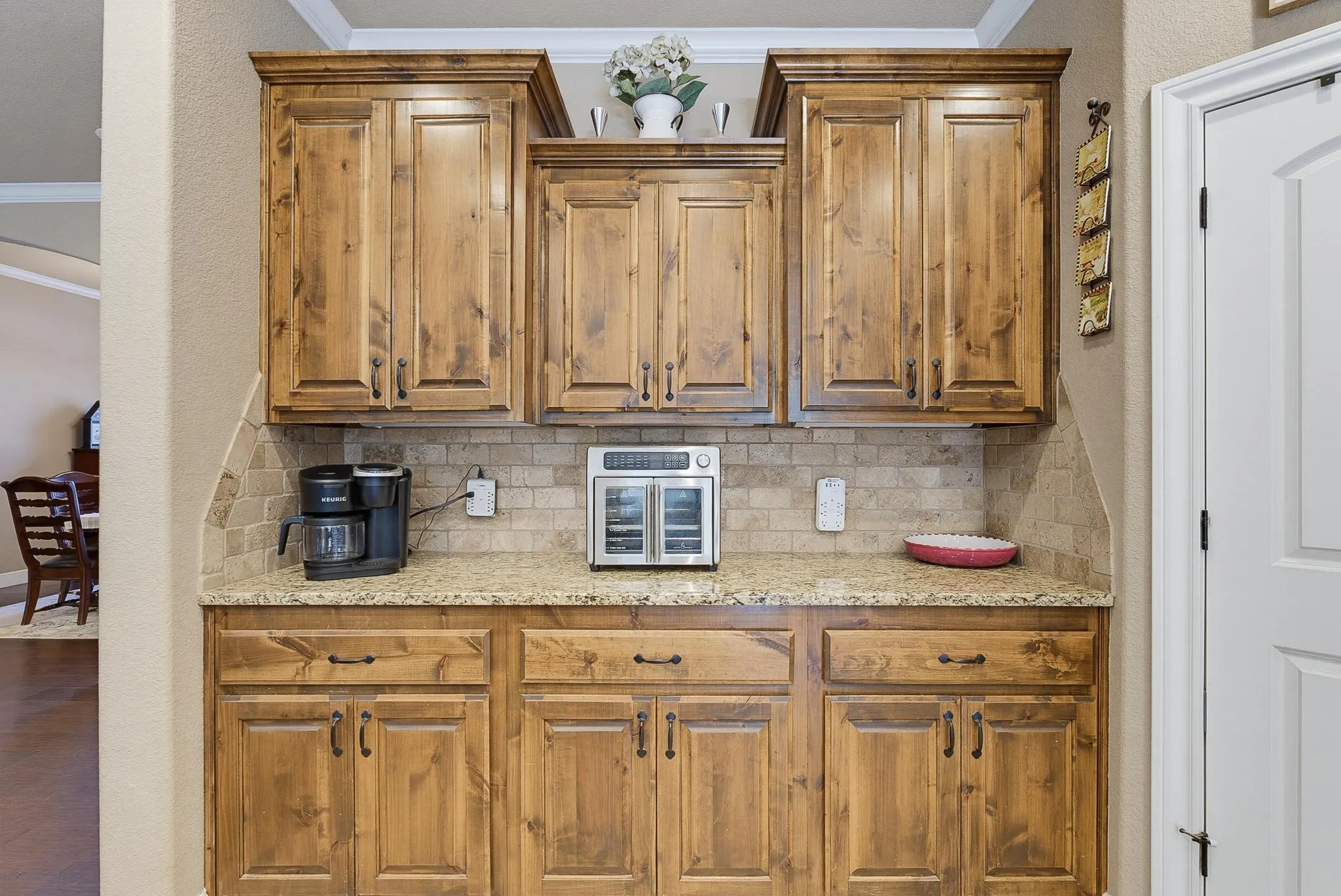 Built-in cabinetry with natural wood-finish doors and dark hardware