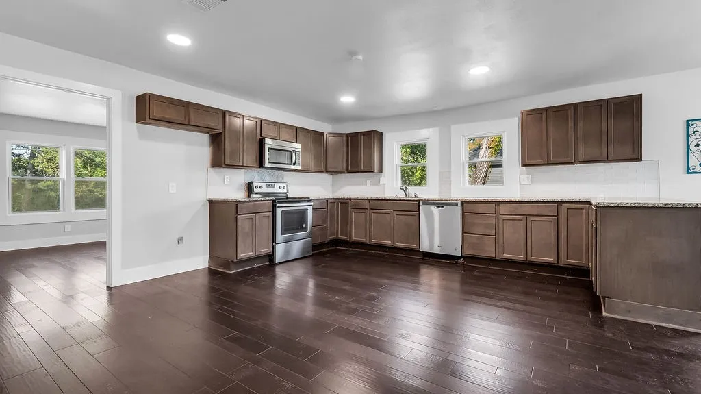 Kitchen featuring dark wood-finish flooring, recessed lighting, and ample cabinetry