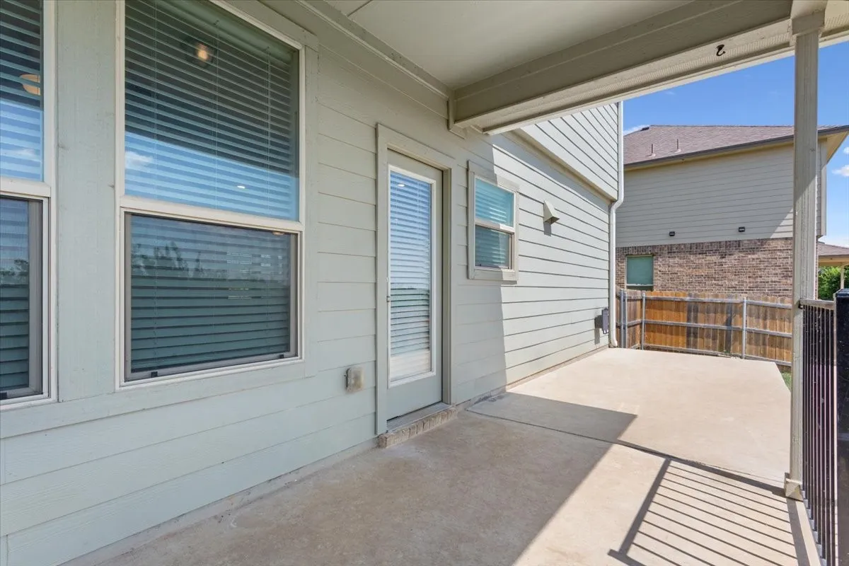 Covered concrete patio with siding exterior