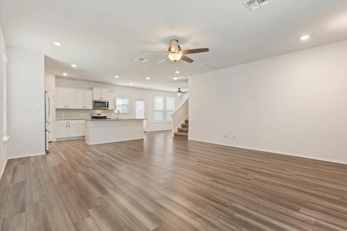 Open-concept living space with wood-finish flooring
