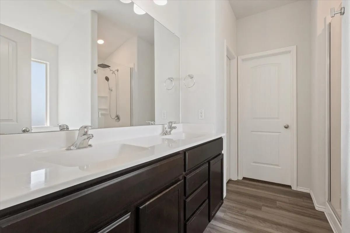 Dual vanity with integrated sinks and chrome fixtures