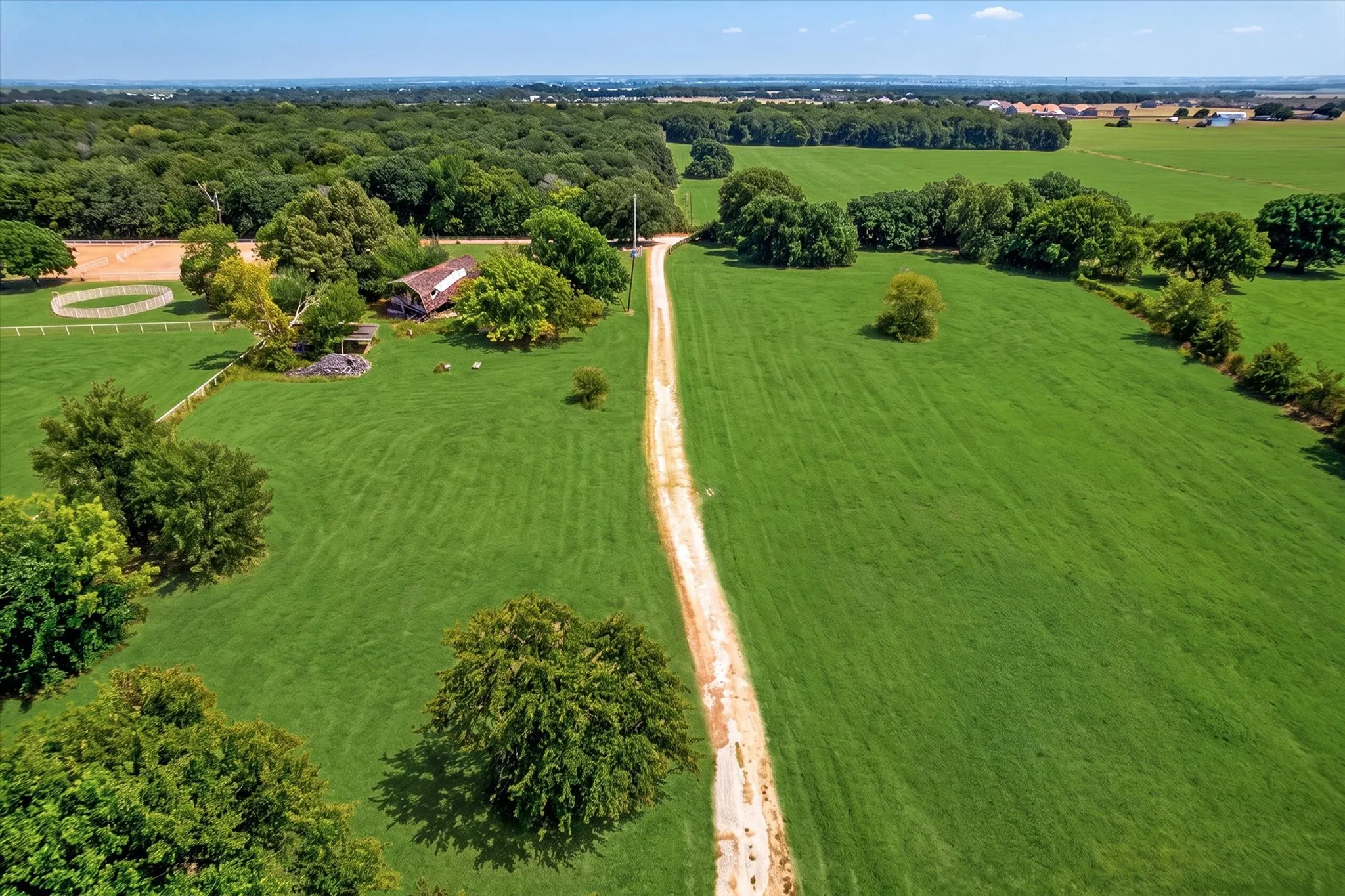 Expansive green acreage with mature trees
