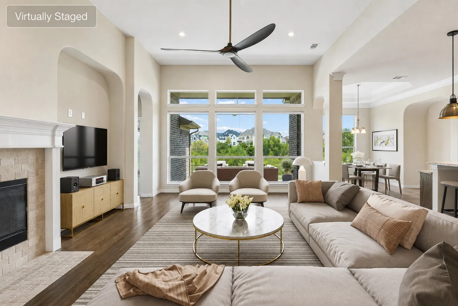 Spacious living area featuring high ceilings and dark wood-finish flooring