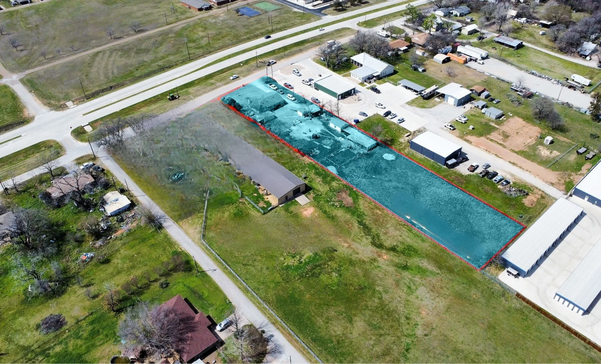 Expansive lot featuring significant road frontage and multiple existing structures