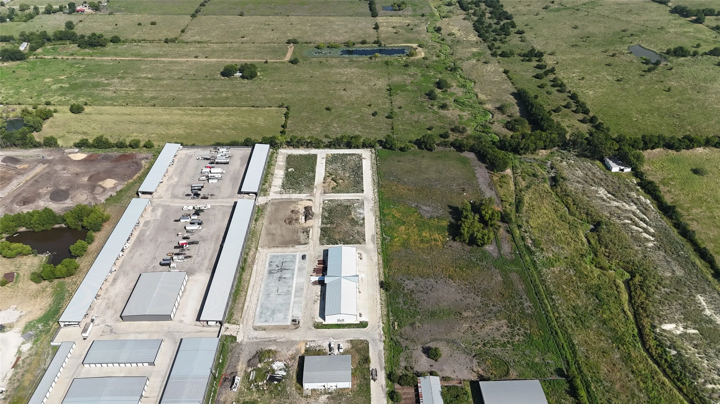 Extensive property featuring multiple large industrial buildings with metal roofs